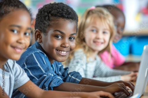 Multiethnic group of children using computers in a classroom.