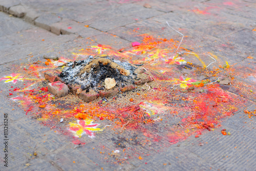 Ashes Left After Worship (Puja) with Flowers, Colour Powder and Drawings on the Ground