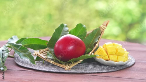 Red mango in Bamboo basket on green bokeh background, Fresh Japanese Elegant mango fruits “Egg of the Sun” Sugar content of 16 degrees on wooden background.