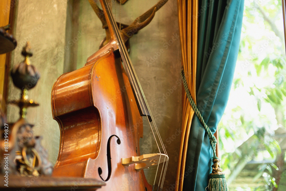 The violin was placed near the window with curtains. The violin was placed near the window with curtains.