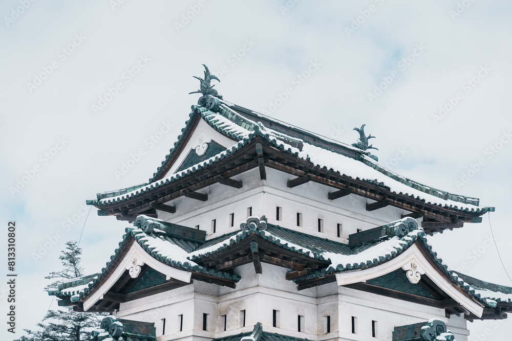 White Hirosaki Castle or Takaoka Castle with snow in winter, hirayama style Japanese castle located in Hirosaki city, Aomori Prefecture, Tohoku, Japan. Landmark for tourist attraction. Japan travel