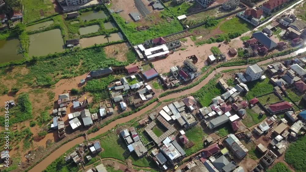 Canal and small homes in residential area of Bukasa, Kampala, Africa. Aerial drone tilt down. Canal and small homes in residential area of Bukasa, Kampala, Africa. Aerial drone tilt down.