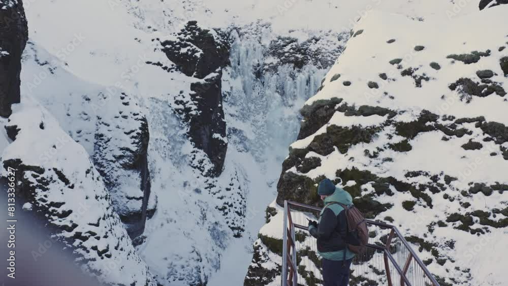 tourist explore the view point of famous landmark Fjaðrárgljúfur canyon, Iceland travel destination