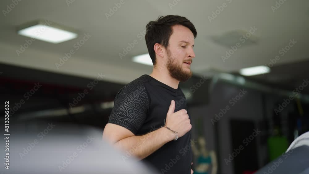 Bearded caucasian male run on indoor gym treadmill, endurance training Bearded caucasian male run on indoor gym treadmill, endurance training