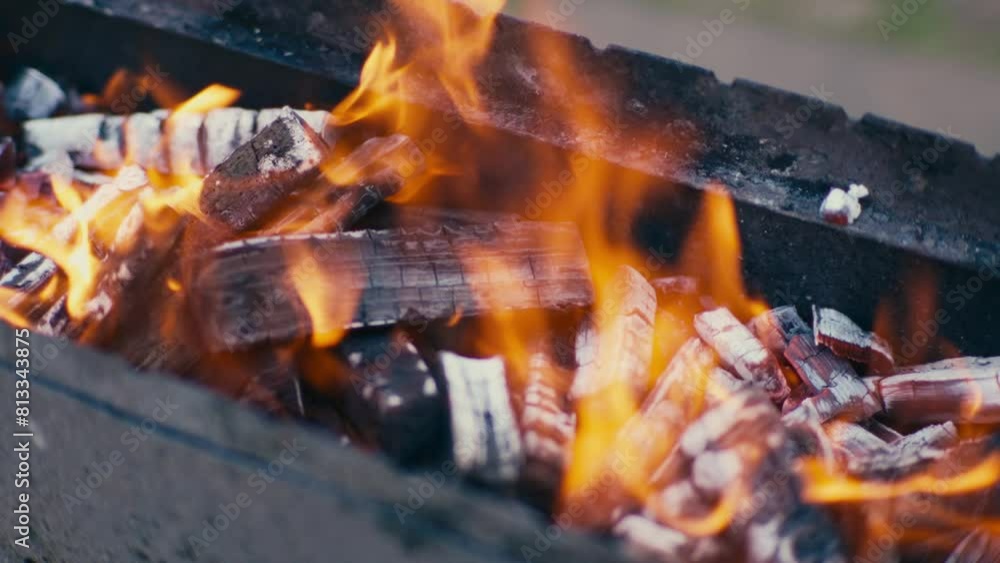 Close up of burned wood turning into coal in flames in bbq grill Close up of burned wood turning into coal in flames in bbq grill