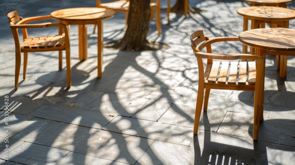 Serene close-up of shadow patterns from trees playing across wooden chairs, blending nature and urban design on an isolated background Serene close-up of shadow patterns from trees playing across wooden chairs, blending nature and urban design on an isolated background