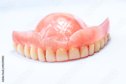 Old denture on a white background.