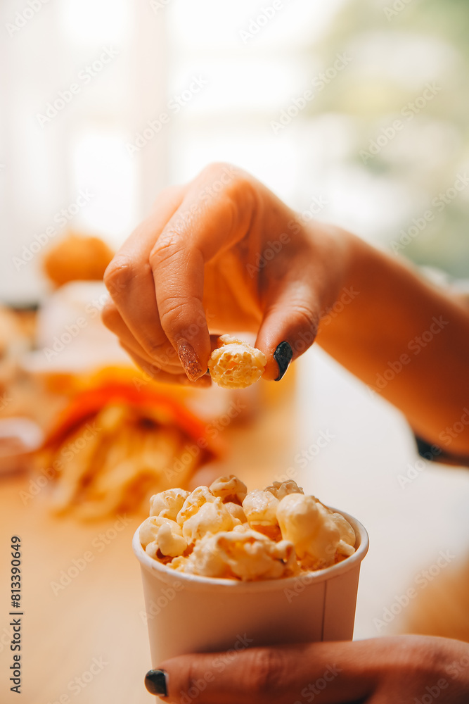 A woman holding a bowl of popcorn A woman holding a bowl of popcorn