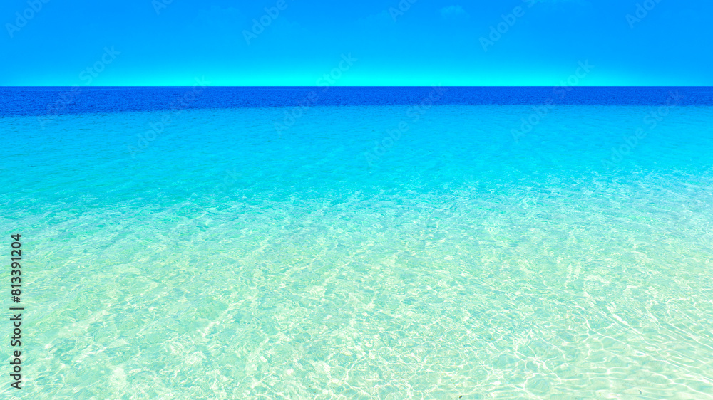 Fototapeta premium Nature of the beach and sea Summer with sunshine, sandy beaches, clear blue waters sparkling against the blue sky. On an island with good ecology and environment Background for summer vacation