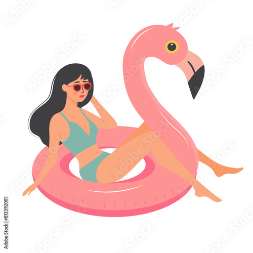Beautiful girl in swimsuit sitting on pink flamingo inflatable ring. Woman relaxing and sunbathing. Summer vacation, holiday, travel, leisure.