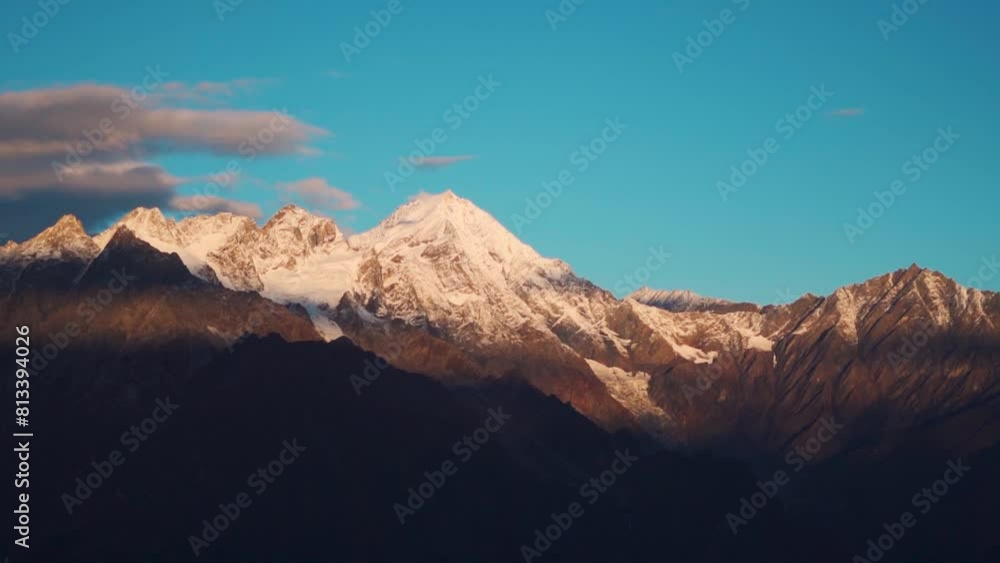 Beautiful view of golden sunlight during morning on snow capped Himalaya mountains in Manali, Himachal Pradesh, India. Sunrise in mountains during summer season. Nature landscape. Beautiful view of golden sunlight during morning on snow capped Himalaya mountains in Manali, Himachal Pradesh, India. Sunrise in mountains during summer season. Nature landscape.