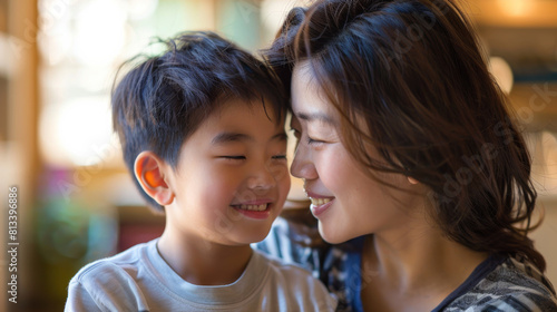 Affectionate moment between smiling Chinese mother and Chinese son at home, showcasing a warm, loving family dynamic