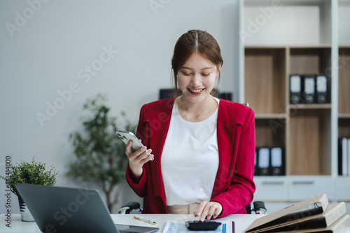 Business woman working at office with laptop and documents on his desk, financial adviser analyzing data.