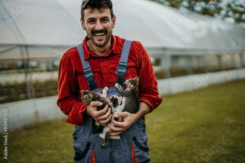 Male farmer and his small kitties