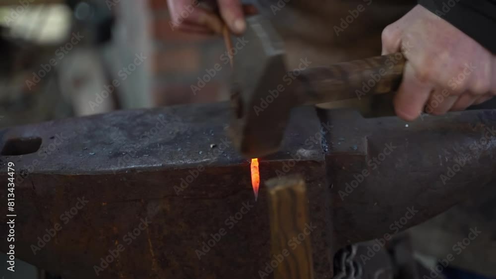 Blacksmith in a forge at work on an anvil. Hot metal forging Blacksmith in a forge at work on an anvil. Hot metal forging