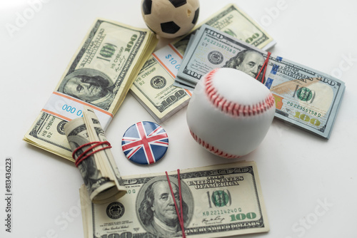 Billede på lærred Small balls on heap of dollars isolated on a white background