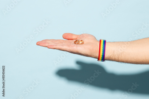 Close up cropped gay male hold hand stretched, hep gesture isolated on pastel plain light blue cyan color wall background studio. Pride day June month love LGBT concept Copy space advertising mock up photo