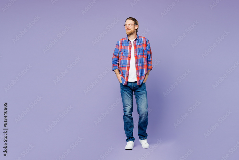 Full body young cheerful satisfied smiling happy man he wear blue shirt casual clothes standing look aside on area isolated on plain pastel light purple background studio portrait. Lifestyle concept. Full body young cheerful satisfied smiling happy man he wear blue shirt casual clothes standing look aside on area isolated on plain pastel light purple background studio portrait. Lifestyle concept.