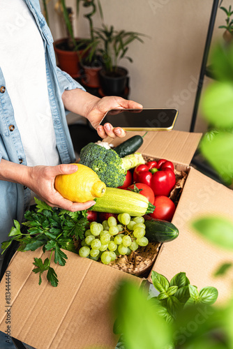 Healthy eating and nutrition. Unpacking online order of farm grown bio vegetables. Delivering of grocery food. photo