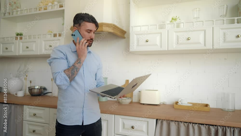 Busy man talking on cell phone at home. Businessman salesman pacing back and forth at home checking information with laptop in his hands, call with clients. Online remote, businessman job concept. Busy man talking on cell phone at home. Businessman salesman pacing back and forth at home checking information with laptop in his hands, call with clients. Online remote, businessman job concept.