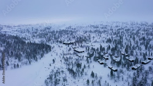Aerial view circling cabins in Kiilopaa, gloomy winter day in Saariselka, Finland photo