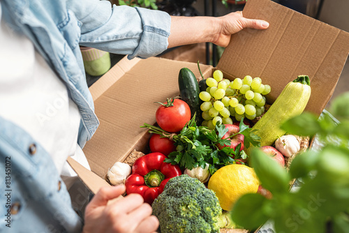 Fototapeta Naklejka Na Ścianę i Meble -  Healthy organic farm grown vegetables and fruits in a delivery cardboard high angle view.