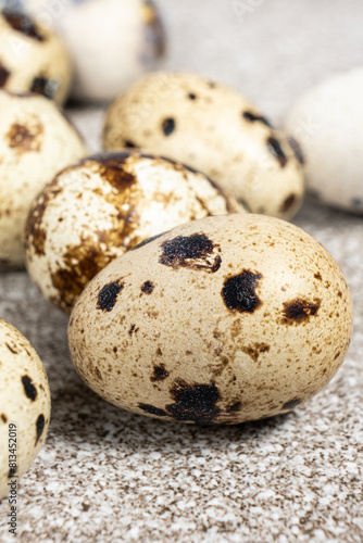 Quail eggs close-up on a gray background.