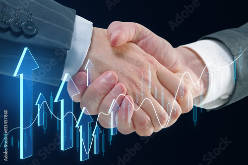 Close up of handshake with creative growing forex chart with arrow on dark background. Financial growth, deal and stock concept.