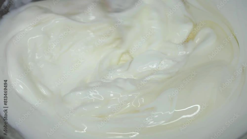Applying creamy sauce to toasted burger buns Applying creamy sauce to toasted burger buns