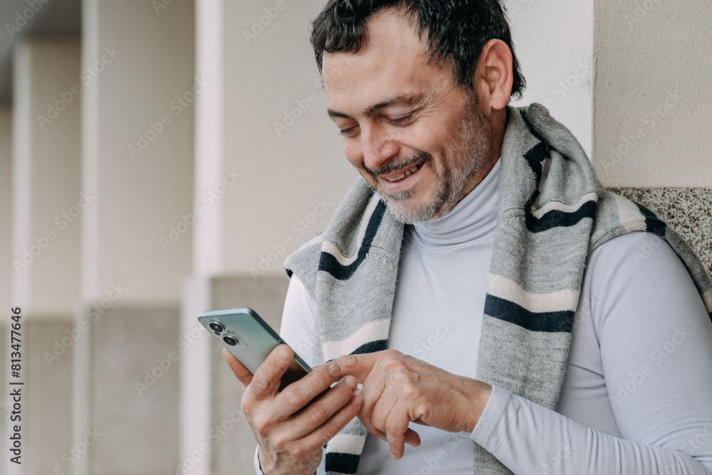 mature man using smartphone on the street mature man using smartphone on the street
