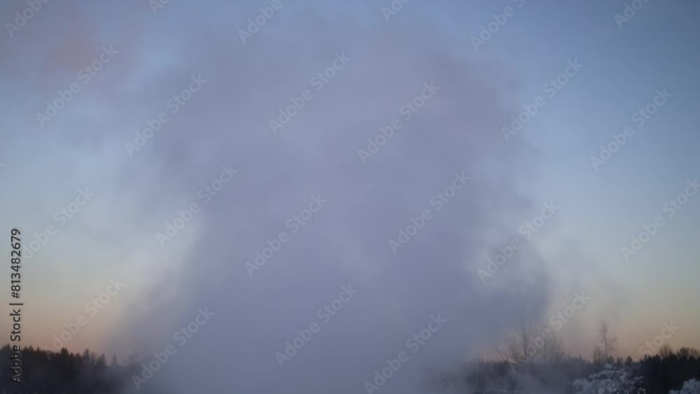 Smoke against the background of the forest. Mist from a hot spring. Steam flies into the sky. Hot smoke in winter. Smoke against the background of the forest. Mist from a hot spring. Steam flies into the sky. Hot smoke in winter.