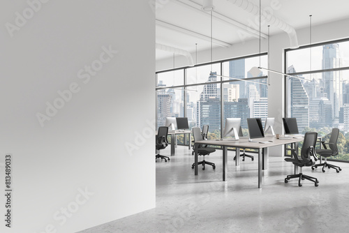 Office workplace interior with pc desktop on tables in row, window. Mockup wall