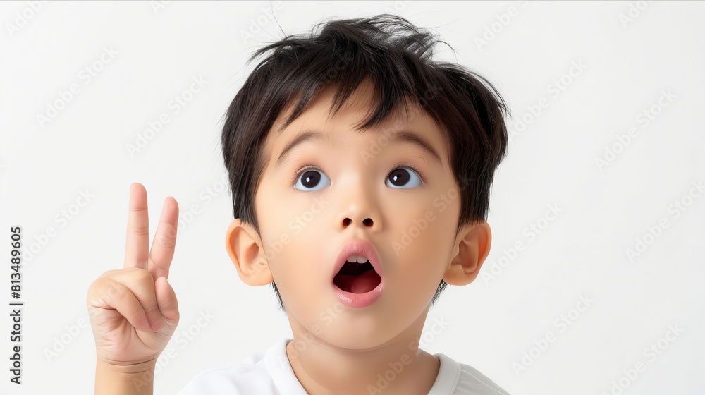 A young boy making a peace sign with his finger. A young boy making a peace sign with his finger.