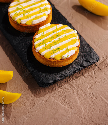 Gourmet mango tarts on slate platter