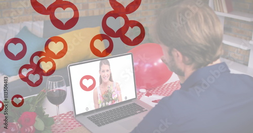 Caucasian couple enjoying virtual date, boyfriend looking at laptop