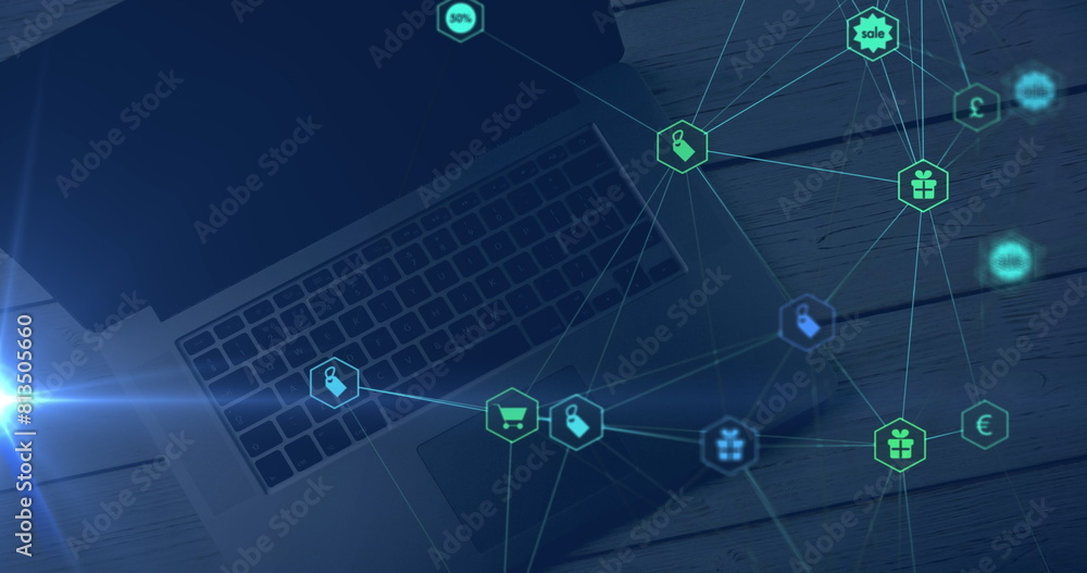 Naklejka premium Blue light trail and network of digital icons against laptop on wooden table