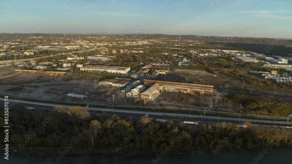 Slow aerial rotating pan across an abandoned industrial steel yard next to highway 24 in Chattanooga, TN during the sunset. Slow aerial rotating pan across an abandoned industrial steel yard next to highway 24 in Chattanooga, TN during the sunset.