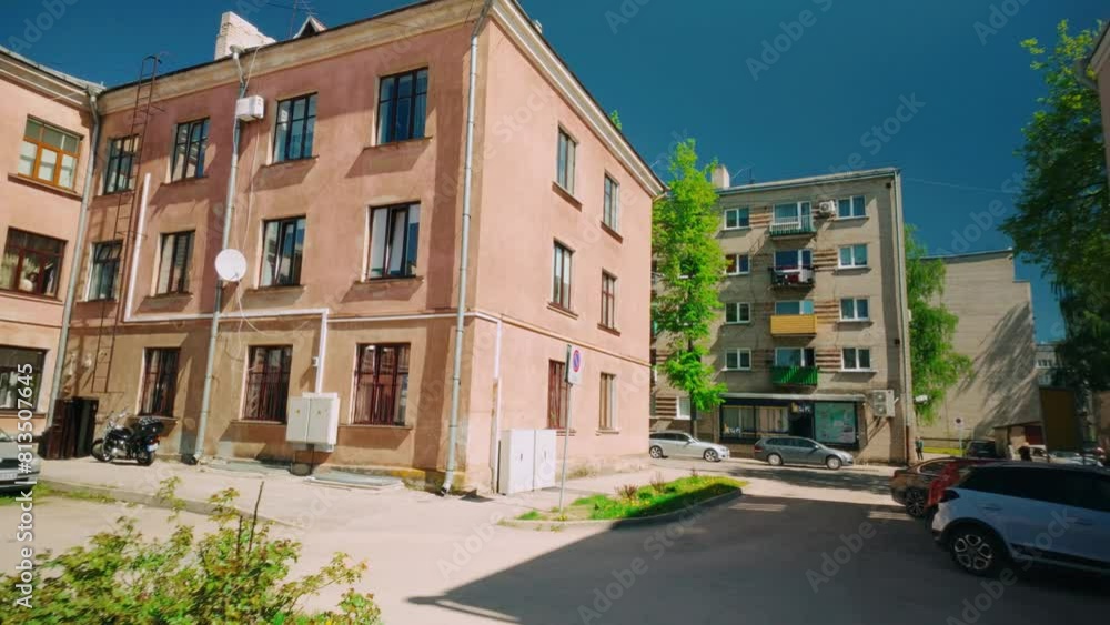 Floating around Mediterranean feel pink house building on sunny day in Daugavpils Floating around Mediterranean feel pink house building on sunny day in Daugavpils