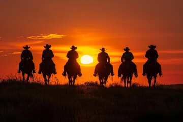 Silhouette of cowboys riding horses at sunset, dramatic orange sky backdrop