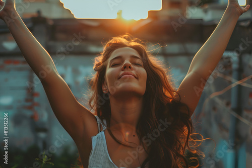 Portrait of determinate woman rising her arms up in the air in sign of self confidence photo