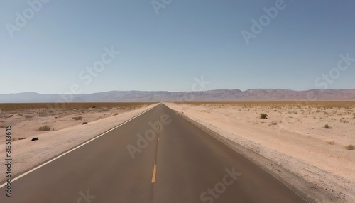 A sun drenched highway traversing the barren deser