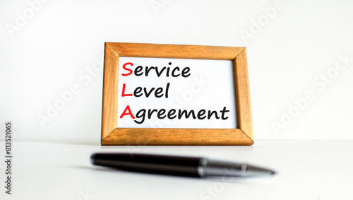 SLA service level agreement symbol. Concept words SLA service level agreement on beautiful wooden frame. Beautiful white background. Business SLA service level agreement concept. Copy space. photo