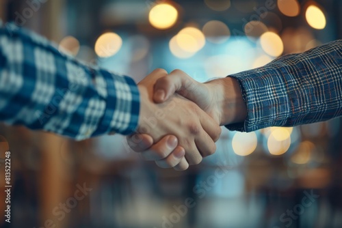 Success at work: close-up business handshake on a blurry bright background
