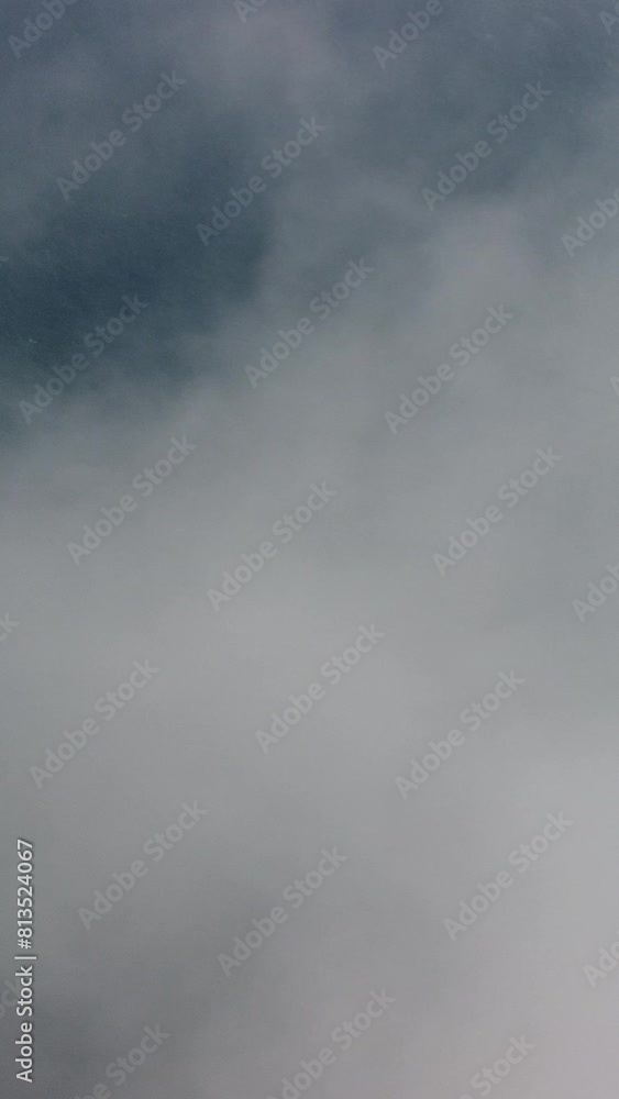 Drone flies over foggy and fluffy clouds. Aerial vertical view. Blue sky sun and sea fog. Abstract aerial nature summer ocean sunset sea and sky background. Vacation, vacation and holiday concept Drone flies over foggy and fluffy clouds. Aerial vertical view. Blue sky sun and sea fog. Abstract aerial nature summer ocean sunset sea and sky background. Vacation, vacation and holiday concept