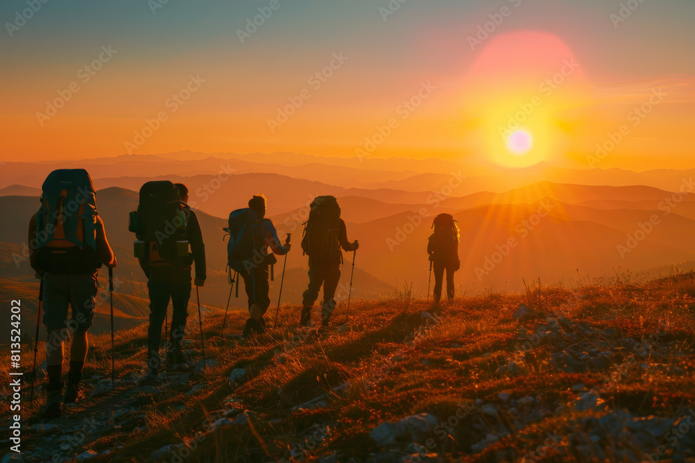 Group of hikers trekking at sunset in mountainous terrain. Group of hikers trekking at sunset in mountainous terrain.