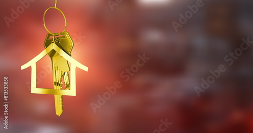 Image of golden house keys hanging against blurred background with copy space