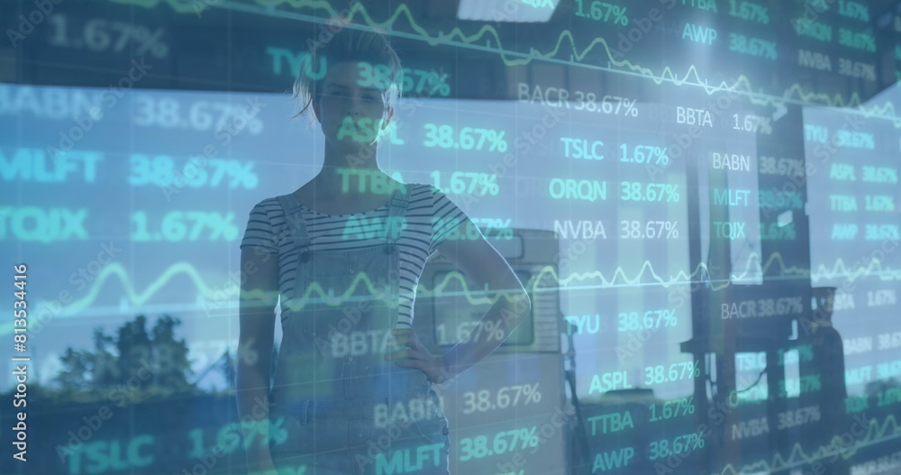 Image of financial data processing over biracial woman fueling car at gas station Image of financial data processing over biracial woman fueling car at gas station