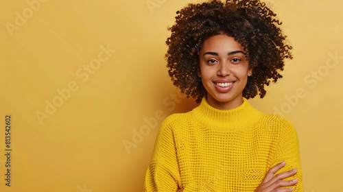 Young beautiful woman model in a yellow sweater on a yellow background © Ruslan