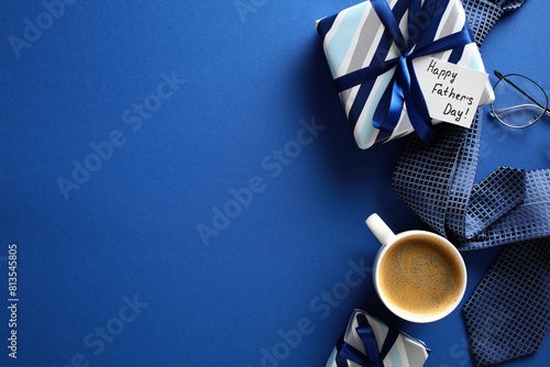 фотографія Festive flat lay composition with coffee, gifts, glasses, and tie on blue backdr