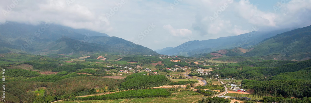 Aerial view of rural landscape with farms and roads amidst rolling hills, suitable for concepts like agriculture, countryside beauty, and Earth Day